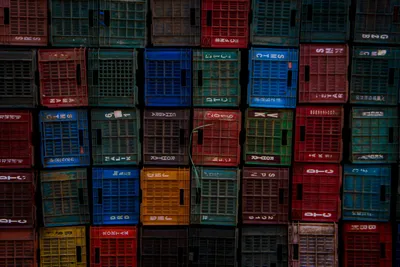 Stacked plastic crates in a working warehouse